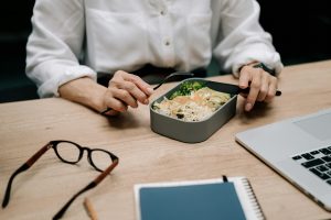 employee eating his lunch at his desk