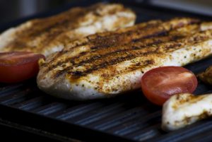 grilled chicken and tomatoes on a griddle pan